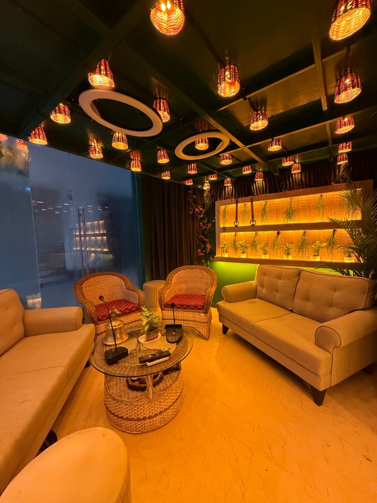 Podcast lounge with sofas, wicker chairs and pendant lights