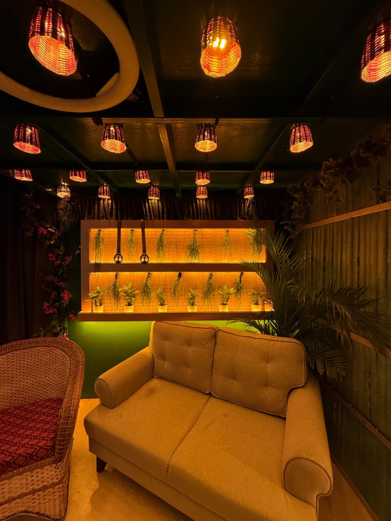 Sofa against backlit plant wall